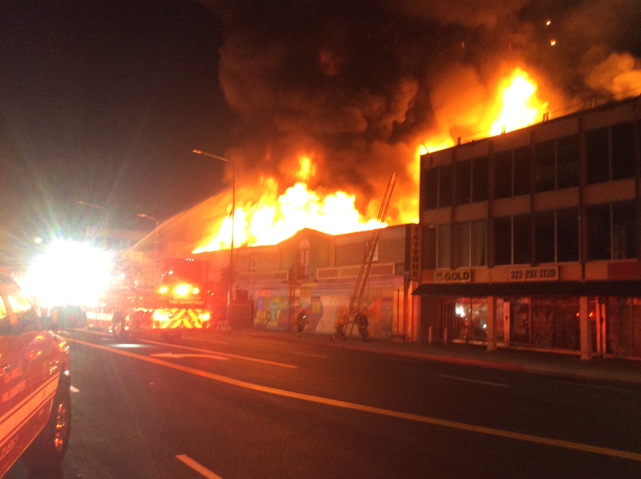 Heavy fire showing from a two story commercial building
