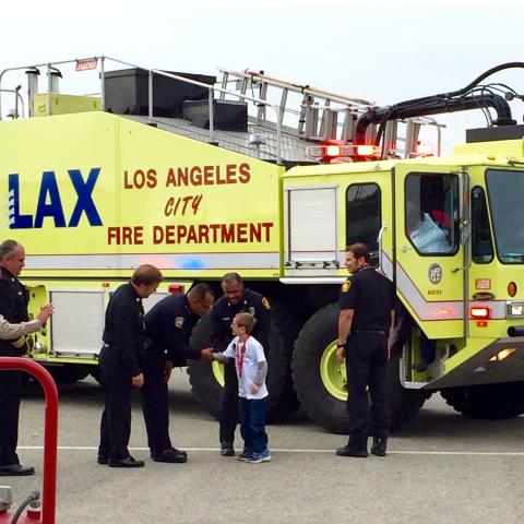 Noah shaking hands with a firefighter