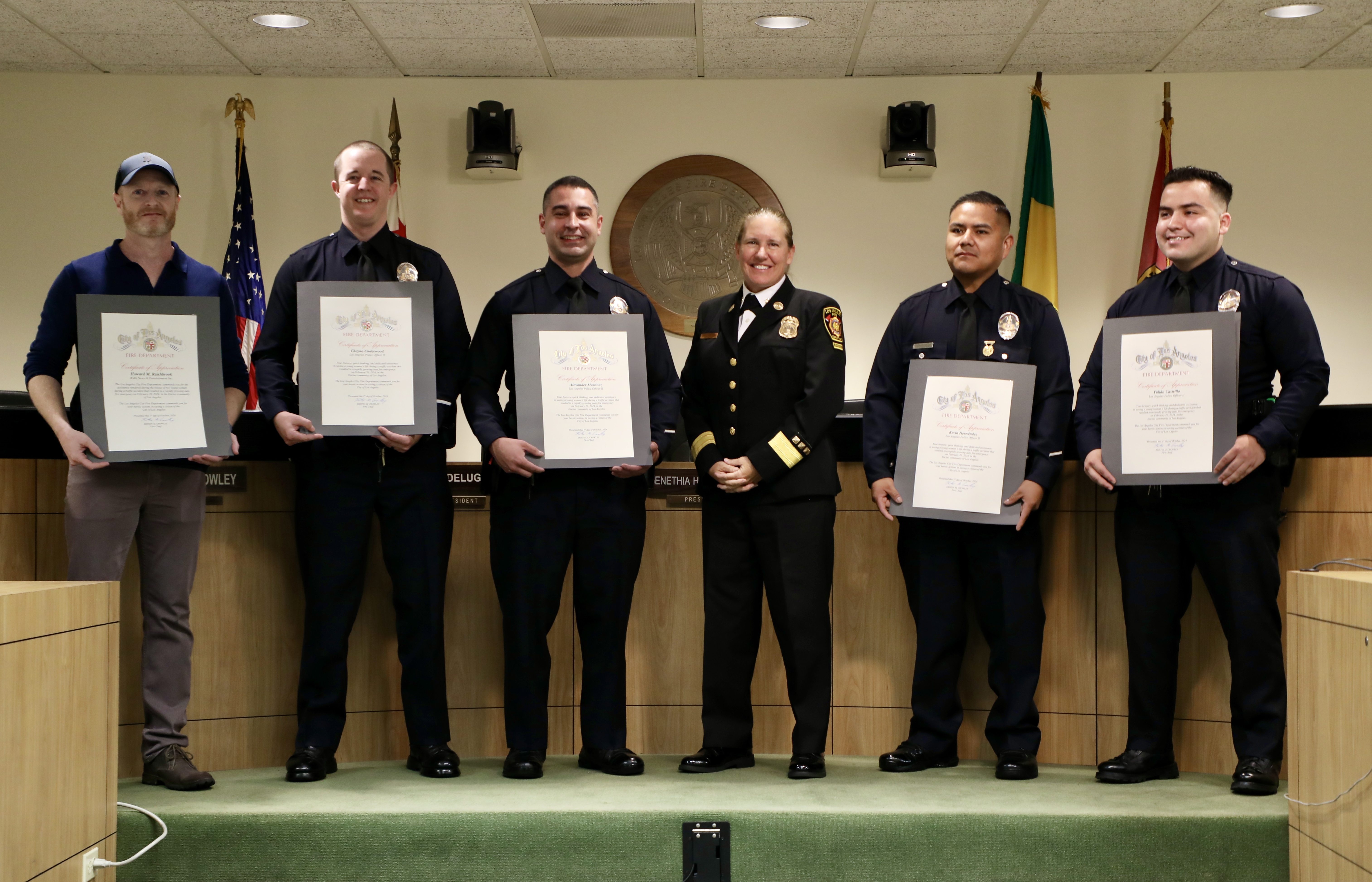 Honorees with their certificates standing with Fire Chief