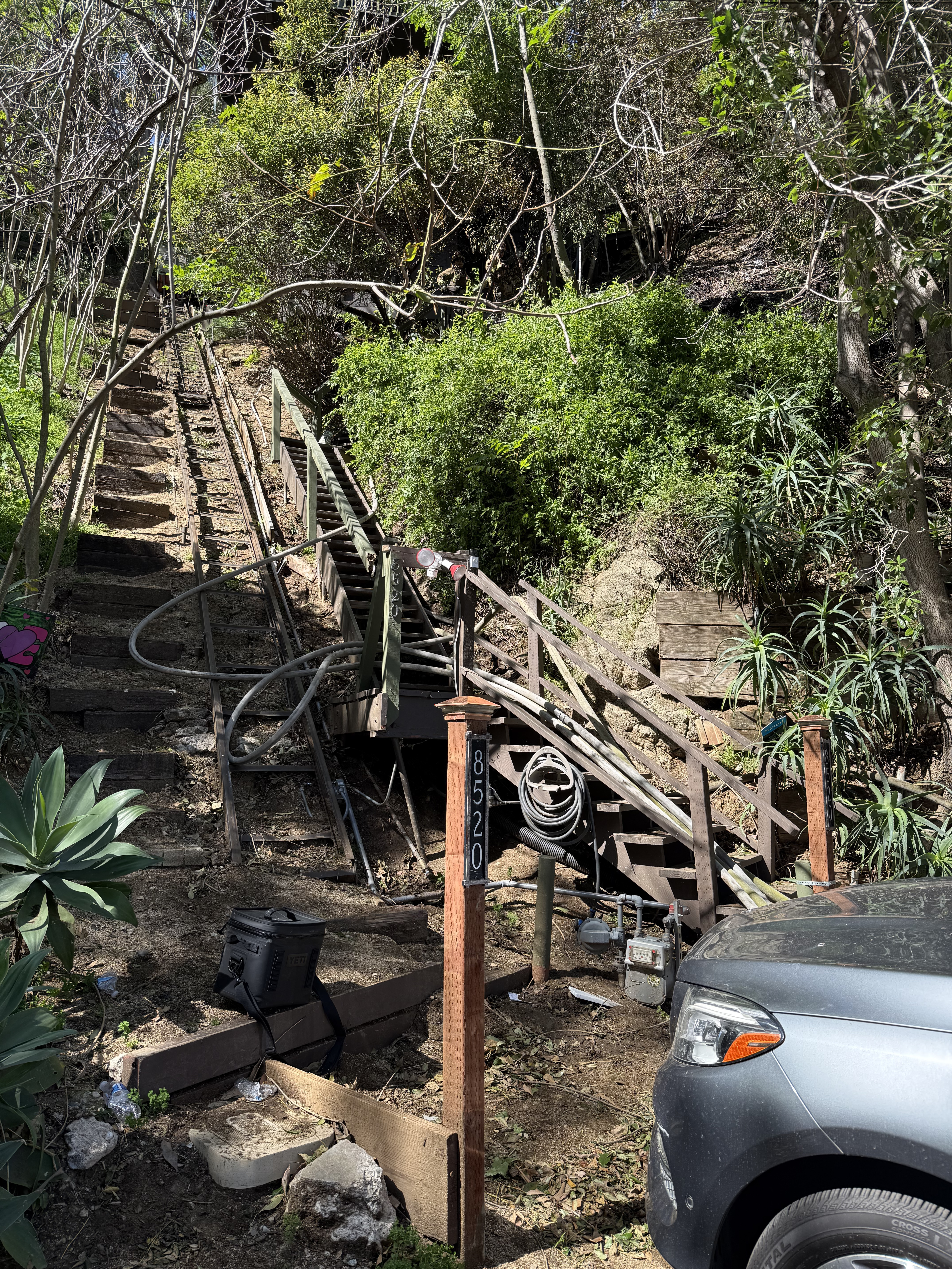 Long, narrow, steep wooden staircase adjacent to the home with the fire lines going up it. Shows how difficult to reach the home