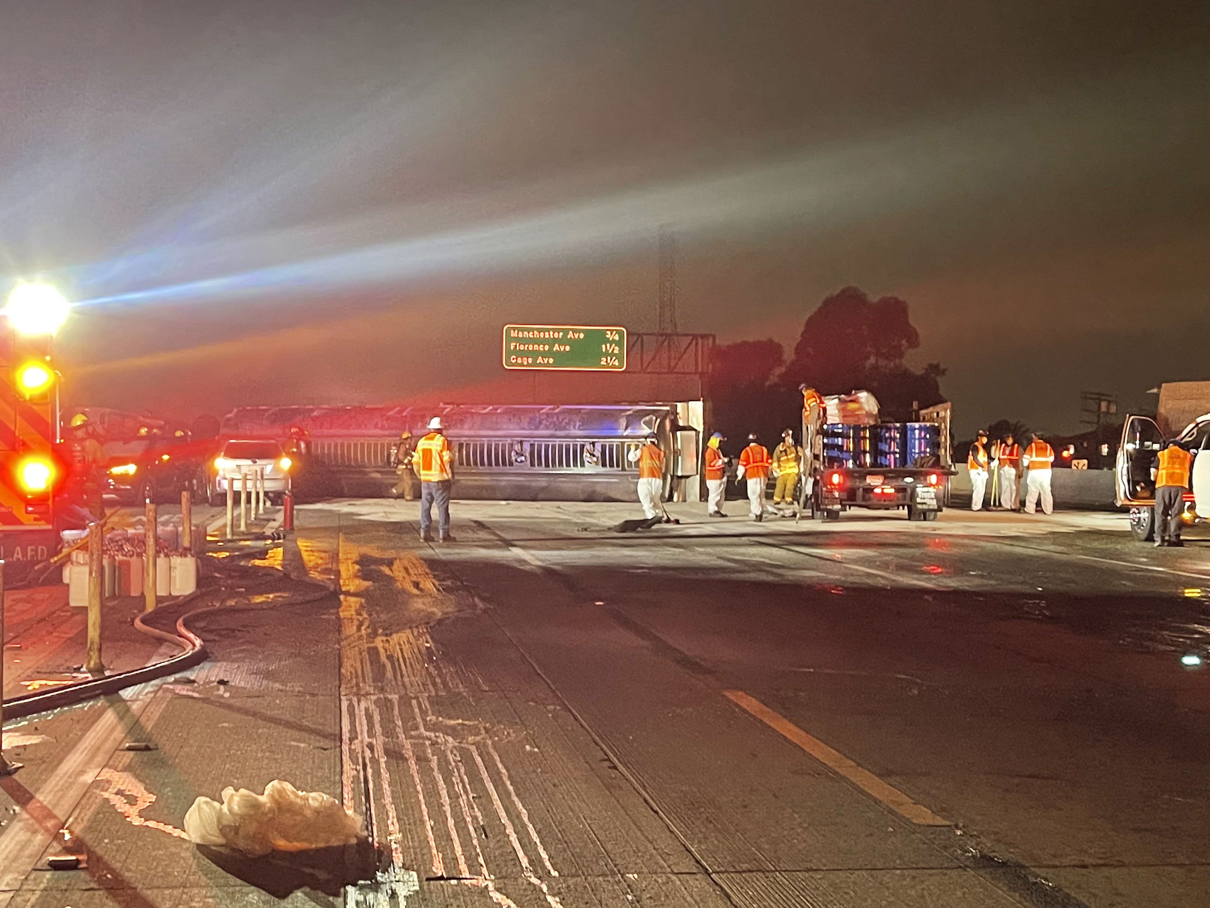 CalTrans and firefighters laying absorbent on freeway 