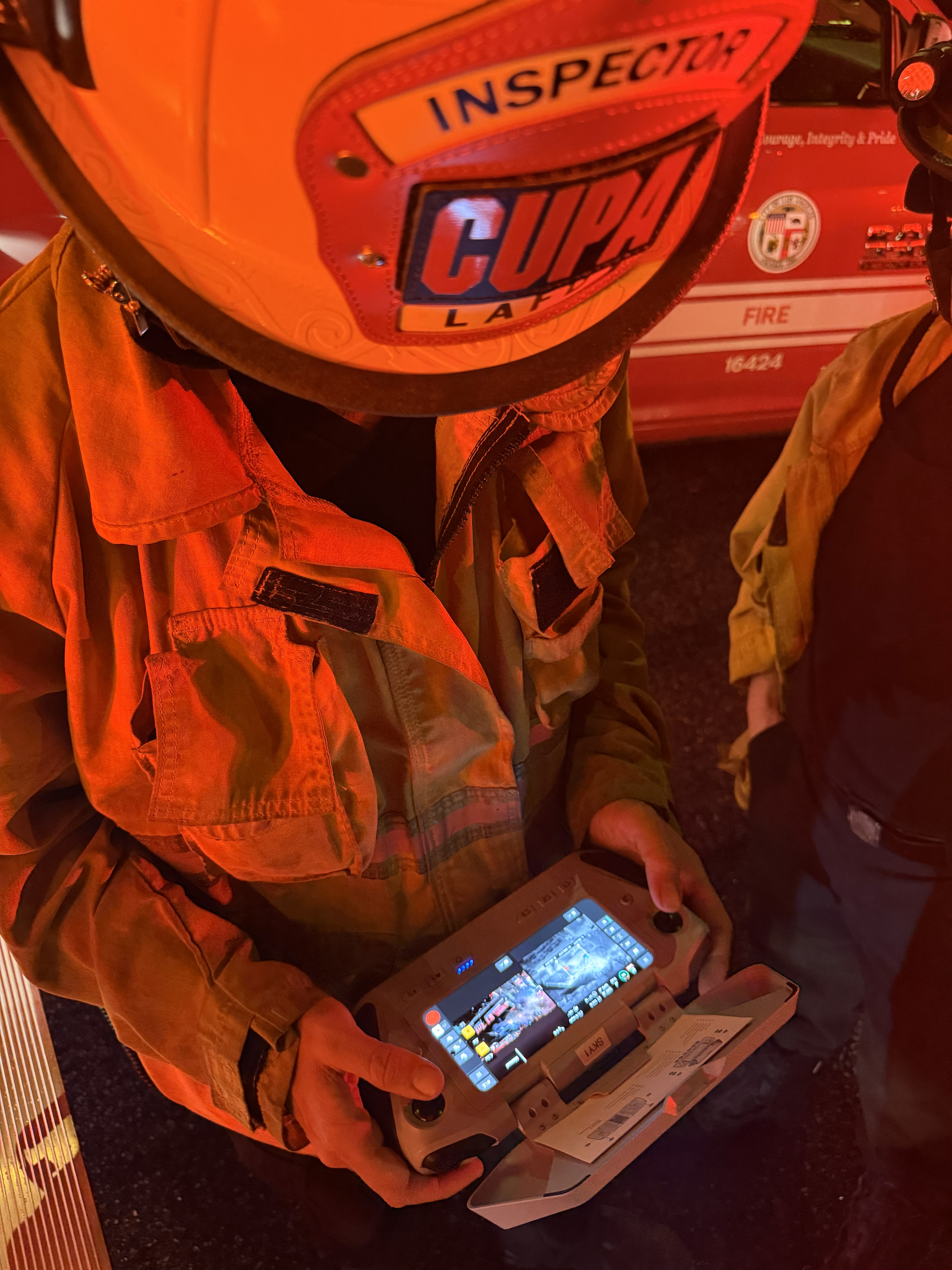 LAFD Inspector looking down at the drone controller