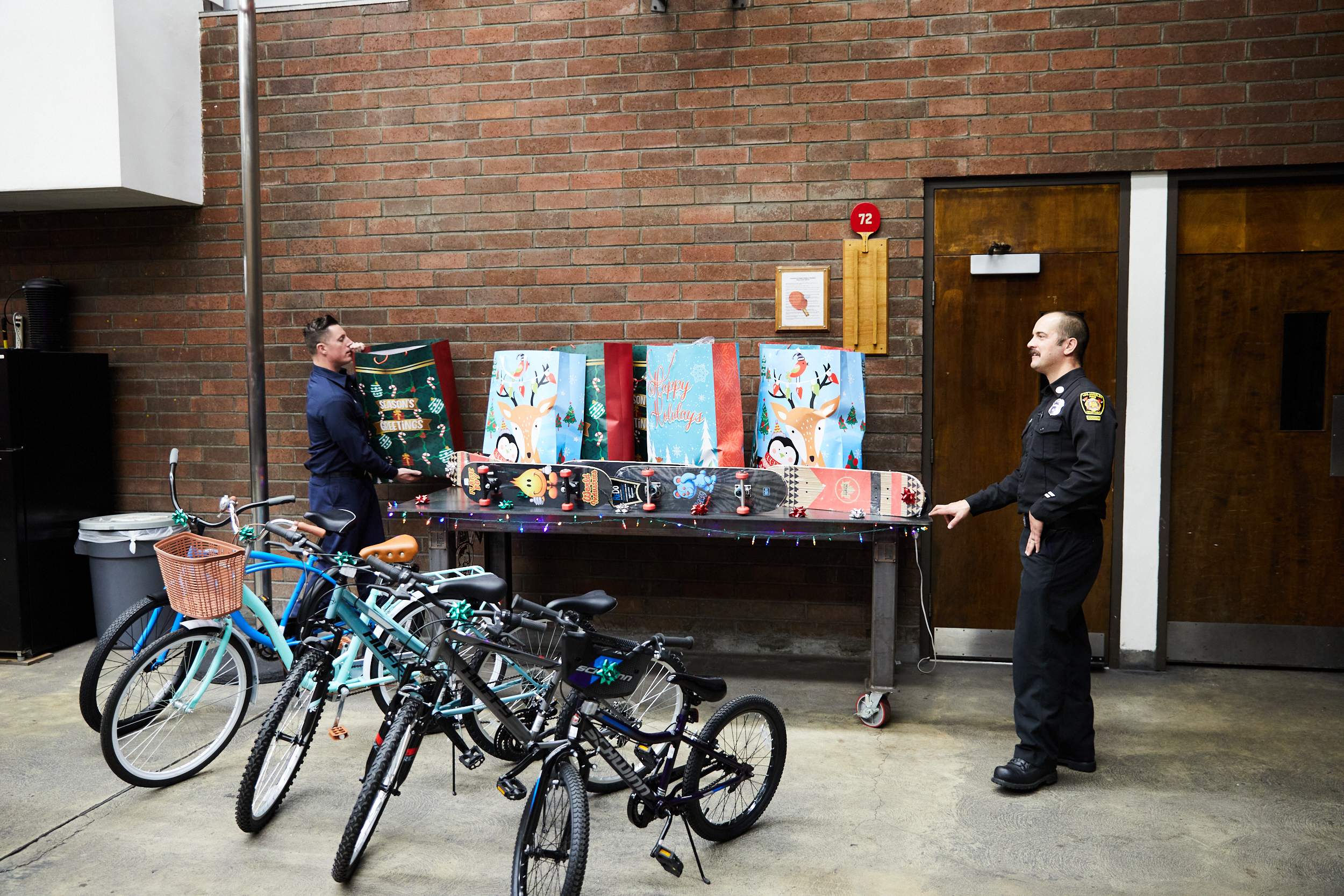 Firefighters pictured with unwrapped toys and sports equipment for the children