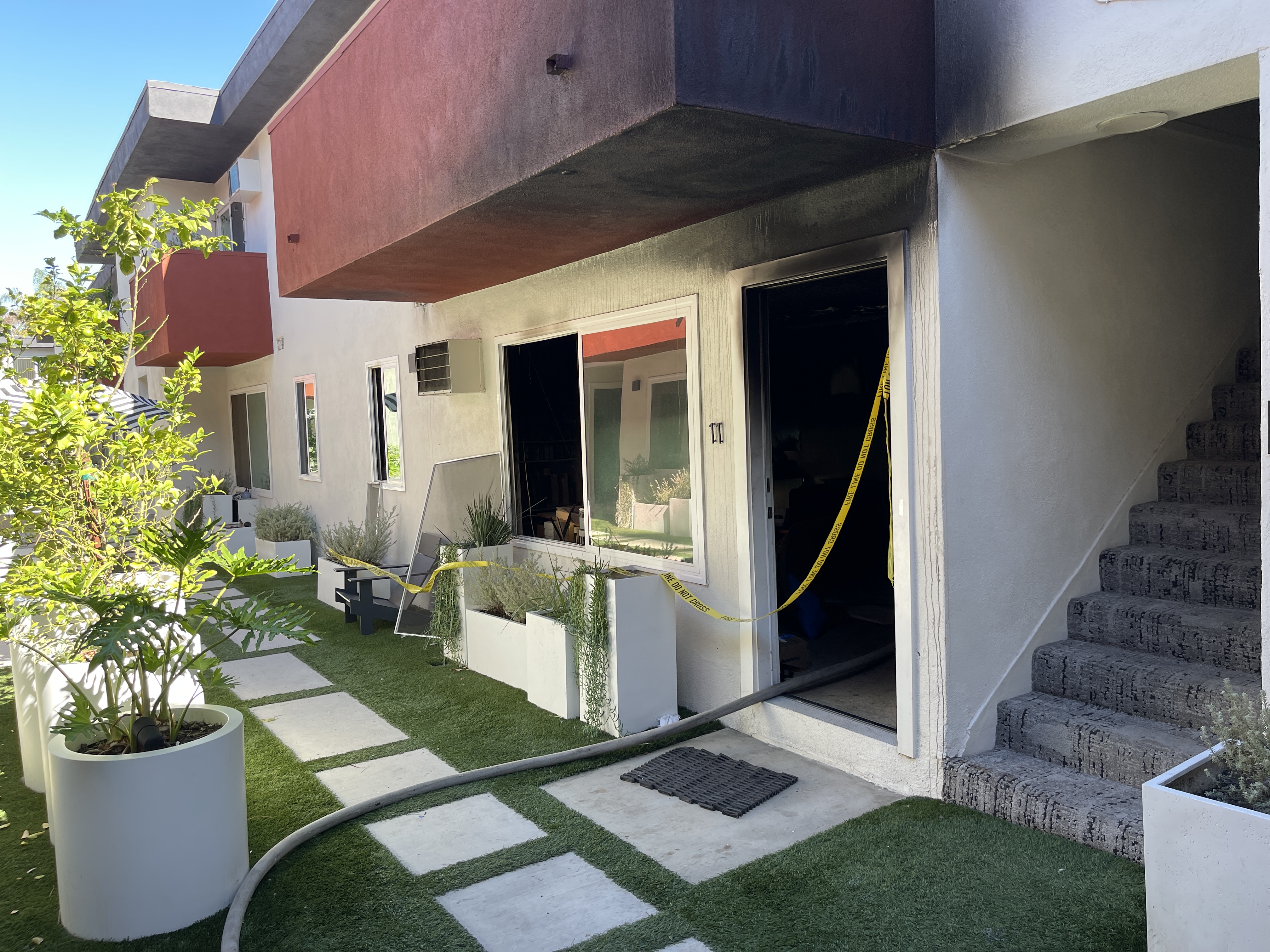 front of apartment unit with visible smoke scars 