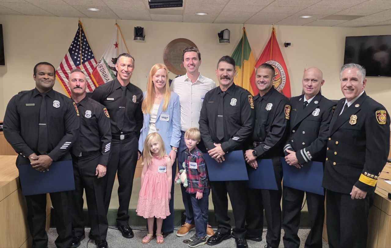 LAFD Station 86 crew stands with three-year-old Keira and her parents during a formal lifesaving recognition ceremony.